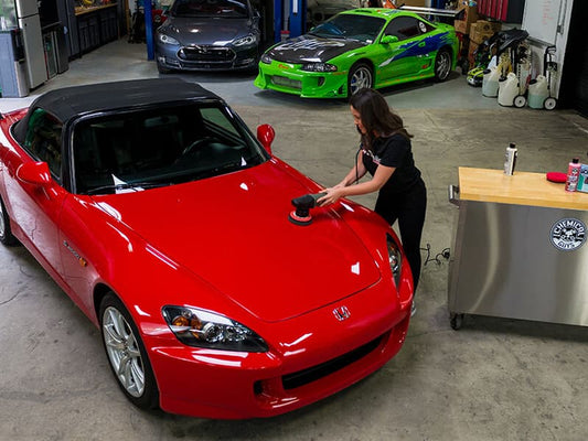 Sealant being applied to a red car