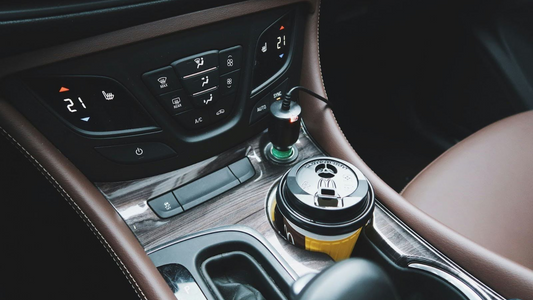 A cup of coffee inside a car’s cupholder