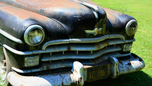 Rusted, old-school car suffering from faded paint