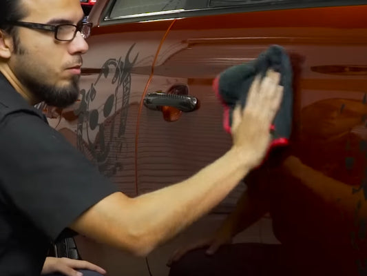 Applying Quick Detail Spray to the Side of a Car