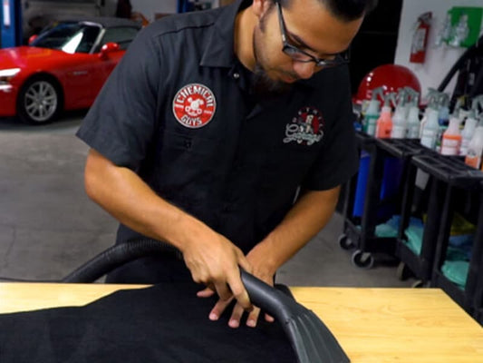 Man Vacuuming Car Carpet