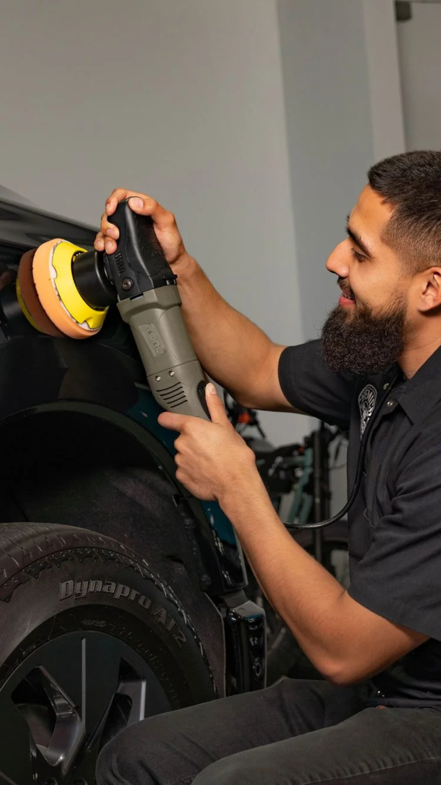 TORQ 10FX Random Orbital Polisher polishing a black vehicle